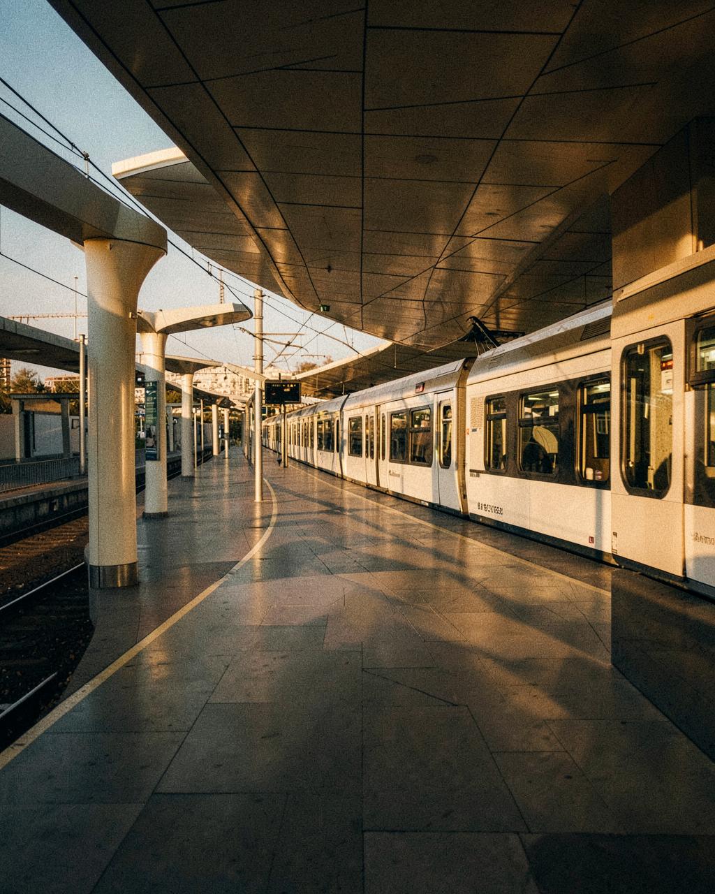 A modern public transit platform in warm evening light